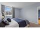Bright bedroom with a window view, carpeted floors, and neutral blue walls, ready for relaxation at 1421 Peachtree Ne St # 304, Atlanta, GA 30309