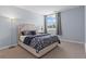 Cozy bedroom featuring plush carpeting, a comfortable bed, and a window offering plenty of natural light at 1421 Peachtree Ne St # 304, Atlanta, GA 30309
