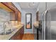 Kitchen with stainless steel appliances, granite countertops, tile backsplash, wood cabinets and a mirror at 1421 Peachtree Ne St # 304, Atlanta, GA 30309