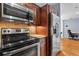 Kitchen showcasing stainless steel appliances, granite counters, tile backsplash, and wood cabinetry at 1421 Peachtree Ne St # 304, Atlanta, GA 30309
