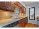 A well-lit kitchen with stainless steel appliances, granite countertops, stone backsplash, and wood cabinetry at 1421 Peachtree Ne St # 304, Atlanta, GA 30309