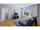 Comfortable living room with hardwood floors, large window and door leading to the hallway at 1421 Peachtree Ne St # 304, Atlanta, GA 30309