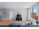 Open living room featuring hardwood floors, a large window, a TV, and access to other rooms at 1421 Peachtree Ne St # 304, Atlanta, GA 30309