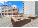Urban rooftop deck with picnic tables, sectional seating and stunning city views at 1421 Peachtree Ne St # 304, Atlanta, GA 30309