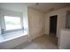 Bright bathroom featuring a soaking tub with a window view and tiled floors at 2522 Bear Mountain St, Lithonia, GA 30058
