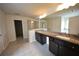Bathroom featuring a double sink vanity with a large mirror and tiled floors at 2522 Bear Mountain St, Lithonia, GA 30058