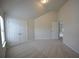 Spacious bedroom with neutral carpet, high ceilings, and a double door closet at 2522 Bear Mountain St, Lithonia, GA 30058