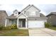 Charming two-story home with gray siding, a covered porch, and a two-car garage at 2522 Bear Mountain St, Lithonia, GA 30058