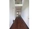 Long hallway with hardwood floors and an open view to the second floor at 2522 Bear Mountain St, Lithonia, GA 30058