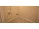 Small laundry room space with gray tile floor, top shelf, and washer/dryer hookups at 2522 Bear Mountain St, Lithonia, GA 30058