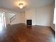 Bright living room boasts a cozy fireplace and beautiful hardwood flooring at 2522 Bear Mountain St, Lithonia, GA 30058