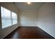 Empty room featuring hardwood floors, white paint, molding, and natural light from the window at 2522 Bear Mountain St, Lithonia, GA 30058