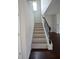 Carpeted staircase leading to the second floor, featuring decorative metal railings and dark wood accents at 2522 Bear Mountain St, Lithonia, GA 30058