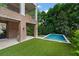 Brick home with a covered patio and a view of the backyard with a modern swimming pool at 27 Maddox Ne Dr, Atlanta, GA 30309