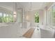 Bright bathroom featuring a soaking tub, large windows, and double vanity at 27 Maddox Ne Dr, Atlanta, GA 30309