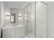 White bathroom showcases a frameless glass shower and a marble vanity with stylish fixtures at 27 Maddox Ne Dr, Atlanta, GA 30309