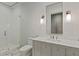 Bright bathroom featuring a glass enclosed shower and marble countertop vanity with modern lighting at 27 Maddox Ne Dr, Atlanta, GA 30309