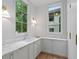 Stylish butler pantry featuring white cabinets and marble countertops at 27 Maddox Ne Dr, Atlanta, GA 30309