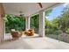 Spacious covered patio with a seating area and wrought iron railing at 27 Maddox Ne Dr, Atlanta, GA 30309