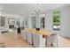 Open concept dining room featuring a large table, hardwood floors, fireplace and windows overlooking greenery at 27 Maddox Ne Dr, Atlanta, GA 30309