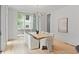 Bright dining room with a large window, modern chandelier, and seating for eight at 27 Maddox Ne Dr, Atlanta, GA 30309
