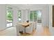 Dining room featuring large windows, hardwood floors, and a modern table with seating for eight at 27 Maddox Ne Dr, Atlanta, GA 30309
