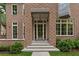 Close-up of a brick home entrance, showcasing the grand door, stone steps, and professional landscaping at 27 Maddox Ne Dr, Atlanta, GA 30309