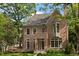 Charming brick home with mature trees, well-manicured lawn, and inviting facade at 27 Maddox Ne Dr, Atlanta, GA 30309