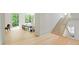 Bright foyer featuring hardwood floors, staircase with white banister, and large windows looking out to greenery at 27 Maddox Ne Dr, Atlanta, GA 30309