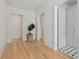 Hallway featuring wood floors, potted tree, and doorway views of black and white tile at 27 Maddox Ne Dr, Atlanta, GA 30309