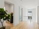 Hallway featuring wood floors, potted tree, and doorway with views to the exterior at 27 Maddox Ne Dr, Atlanta, GA 30309