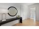 Hallway featuring a console table with a decorative mirror and vase, and an open doorway at 27 Maddox Ne Dr, Atlanta, GA 30309