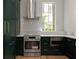 Open concept kitchen featuring stainless steel appliances, dark cabinets and a modern tile backsplash at 27 Maddox Ne Dr, Atlanta, GA 30309