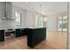 Modern kitchen with stainless steel appliances, a custom island, and a light wood floor at 27 Maddox Ne Dr, Atlanta, GA 30309