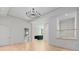 Open-concept living room featuring a modern chandelier, hardwood floors, and an open staircase at 27 Maddox Ne Dr, Atlanta, GA 30309