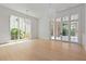 Spacious living room featuring hardwood floors, large windows, and modern lighting at 27 Maddox Ne Dr, Atlanta, GA 30309