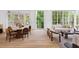 Open concept living space featuring hardwood floors, neutral furniture, and large windows overlooking greenery at 27 Maddox Ne Dr, Atlanta, GA 30309