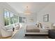 Bright main bedroom featuring large windows, sitting area, stylish decor, and natural light at 27 Maddox Ne Dr, Atlanta, GA 30309