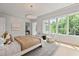 Bright main bedroom featuring large windows, sitting area, and stylish decor at 27 Maddox Ne Dr, Atlanta, GA 30309