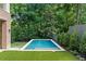 Backyard featuring a modern swimming pool surrounded by lush landscaping and artificial turf at 27 Maddox Ne Dr, Atlanta, GA 30309