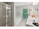 Bright bathroom featuring double sinks, soaking tub and glass enclosed shower at 576 Fraser Se St, Atlanta, GA 30312