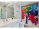 Colorful bathroom with large vanity and shower with designer curtain at 576 Fraser Se St, Atlanta, GA 30312
