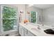 Bathroom with double vanity, large mirror, and window offering natural light at 576 Fraser Se St, Atlanta, GA 30312