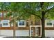 Charming townhome featuring a brick facade, arched windows, a two-car garage, and a covered entryway at 576 Fraser Se St, Atlanta, GA 30312