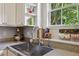 Close-up of kitchen sink area with stainless steel sink and designer faucet at 576 Fraser Se St, Atlanta, GA 30312