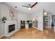 Cozy living room featuring hardwood floors, a fireplace, a ceiling fan, and a staircase at 576 Fraser Se St, Atlanta, GA 30312