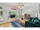 Bright living room with a large window, plush green sofa, and colorful rug at 576 Fraser Se St, Atlanta, GA 30312