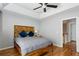 Main bedroom featuring a tray ceiling, wooden furniture, and hardwood floors at 576 Fraser Se St, Atlanta, GA 30312