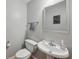 Clean powder room with a pedestal sink, modern fixtures, and neutral color scheme at 576 Fraser Se St, Atlanta, GA 30312