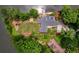 Aerial view of a waterfront home with lush landscaping, private dock, and expansive lawn at 3125 Cardinal Lake Cir, Duluth, GA 30096